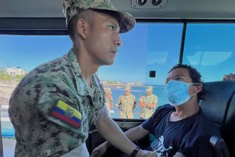 In this government handout photo a soldier checks the vitals of one of five shipwrecked fishermen, who were rescued after being adrift for more than 50 days, at the San Cristobal Naval Base, Galapagos Islands, on May 10.