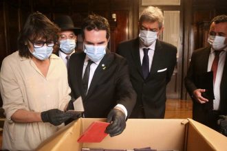 Officials inspect documents associated with the Nazi regime found by staffers in the Supreme Court's archives in Buenos Aires on May 11.