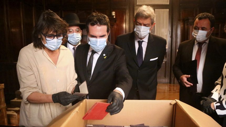 Officials inspect documents associated with the Nazi regime found by staffers in the Supreme Court's archives in Buenos Aires on May 11.