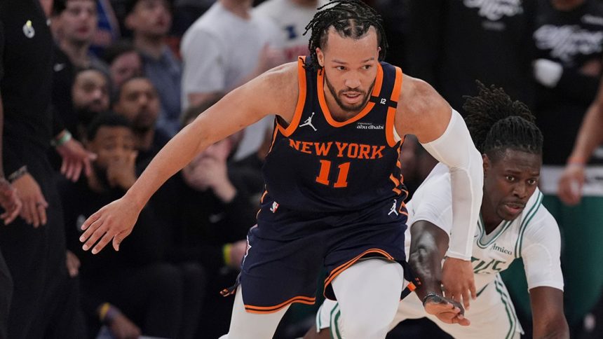 New York Knicks guard Jalen Brunson fights for control of the ball with Boston Celtics' Jrue Holiday on Monday in New York.