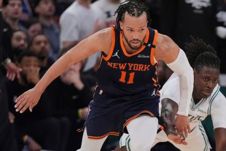 New York Knicks guard Jalen Brunson fights for control of the ball with Boston Celtics' Jrue Holiday on Monday in New York.