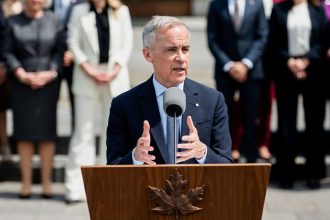 Canadian Prime Minister Mark Carney speaks to reporters following his cabinet's swearing-in ceremony at Rideau Hall in Ottawa on Tuesday.