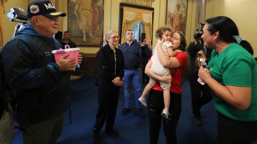 Venezuelan first lady Cilia Flores, second from left, and Interior Minister Diosdado Cabello, left, watch as 2-year-old Maikelys Espinoza is reunited with her mother Yorely Bernal at Miraflores presidential palace in Caracas, Venezuela, on Wednesday.