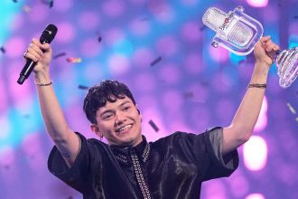 Winner of the Eurovision Song Contest, JJ from Austria, holds up the trophy onstage after winning the 69th Eurovision Song Contest in Basel, Switzerland.