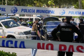 Police officers cordon off the area outside The American School of Madrid shortly after the former senior aide to ex-Ukrainian president Viktor Yanukovych was shot.