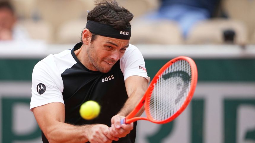 Fritz plays a backhand during his French Open defeat against Daniel Altmaier.