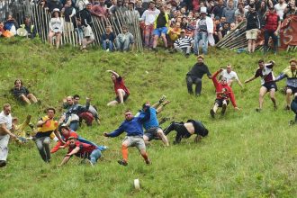 Competitors take part in the annual Cooper's Hill cheese rolling race in Brockworth, England.