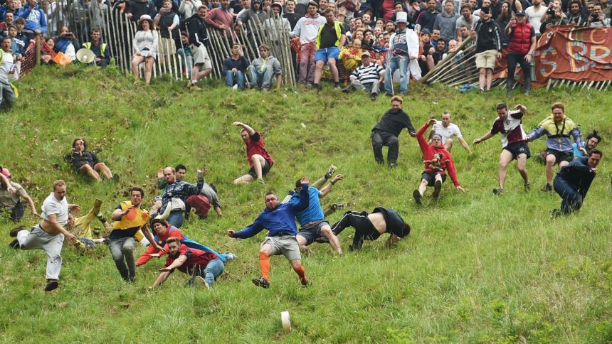 Competitors take part in the annual Cooper's Hill cheese rolling race in Brockworth, England.