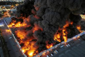 Drone view of the Marywilska 44 shopping centre burning during a massive fire in Warsaw, Poland, on May 12, 2024.