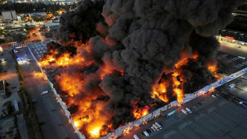 Drone view of the Marywilska 44 shopping centre burning during a massive fire in Warsaw, Poland, on May 12, 2024.