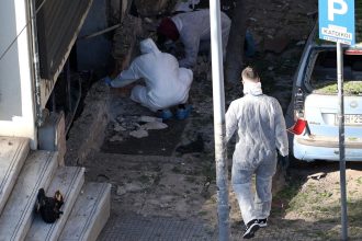 Forensics officers investigate the area of a blast caused by an explosive device outside a bank that killed a 38-year old woman in Thessaloniki, Greece on May 3.