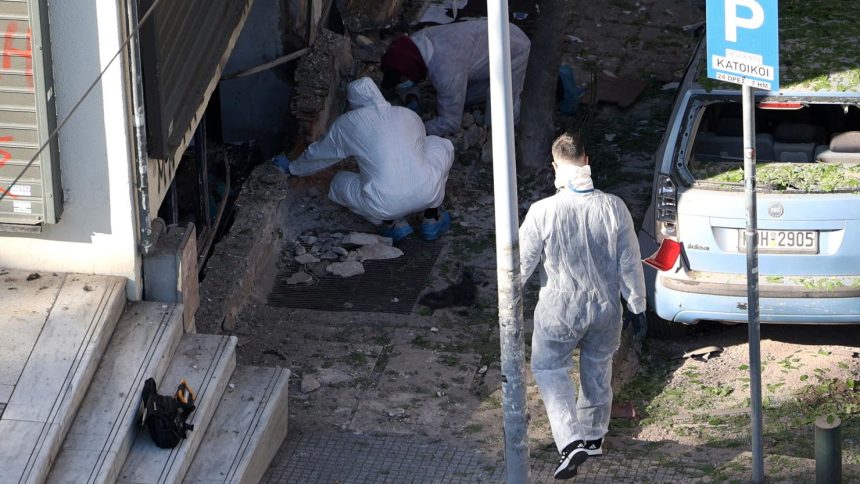 Forensics officers investigate the area of a blast caused by an explosive device outside a bank that killed a 38-year old woman in Thessaloniki, Greece on May 3.