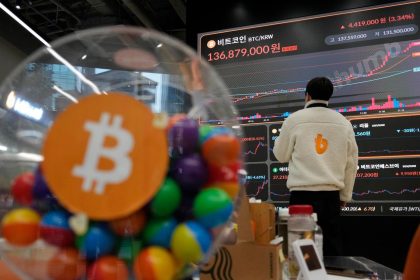 An employee watches an electronic signboard displaying the prices of Bitcoin and other cryptocurrencies at the lounge of Bithumb cryptocurrency exchange in Seoul, South Korea, in November.