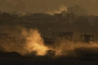 An Israeli army tank maneuvers in the Gaza Strip is seen from southern Israel on May 4.