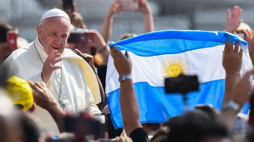 A worshiper waves the flag of Argentina as Pope Francis arrives for the weekly general audience on June 5, 2019 at St. Peter's square in the Vatican.