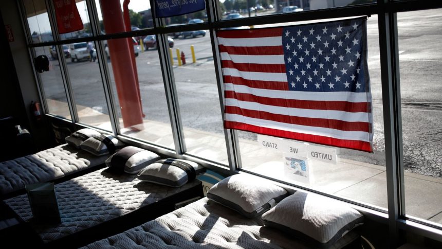 In this June 2022 photo, a US flag is seen above mattresses at Charlie Wilson's appliance and TV store in Clarksville, Indiana.