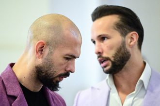 Andrew Tate, left, and his brother Tristan Tate are pictured inside The Court of Appeal in Bucharest, Romania, on December 10, 2024.