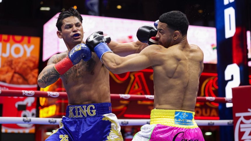 Ryan Garcia and Rolly Romero exchange punches during a fight for the WBA Welterweight title in Times Square on May 2 in New York City.