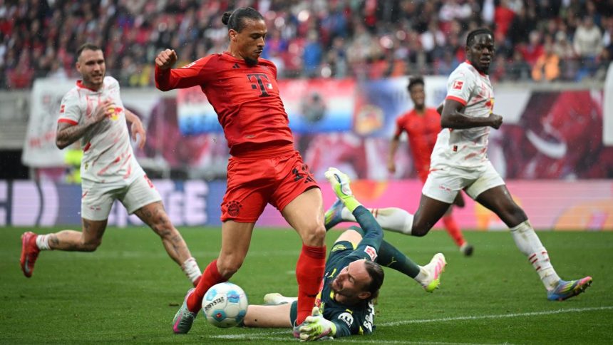 Leroy Sane of Bayern Munich is brought down by Maarten Vandevoordt of RB Leipzig during the Bundesliga match between RB Leipzig and FC Bayern München at Red Bull Arena on May 3, 2025 in Leipzig, Germany.