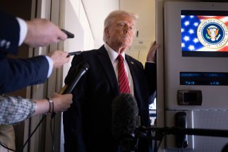 President Donald Trump listens to questions as he speaks to members of the press on Air Force One while flying over Saudi Arabia on his way to Qatar on May 14.