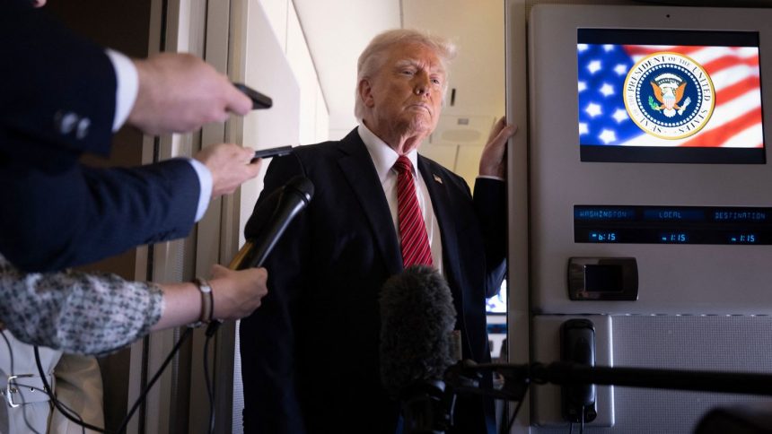 President Donald Trump listens to questions as he speaks to members of the press on Air Force One while flying over Saudi Arabia on his way to Qatar on May 14.