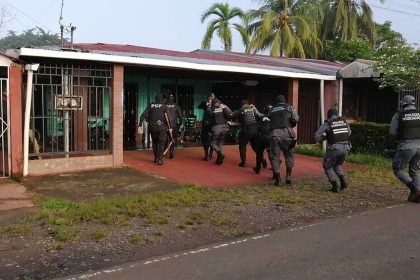 Costa Rican immigration police raid a building on May 28, 2025, in connection with a human trafficking investigation.