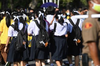 Students wearing the standard Thai school uniform and white ribbons in their hair as a sign of protest in Bangkok, Thailand, on August 19, 2020.