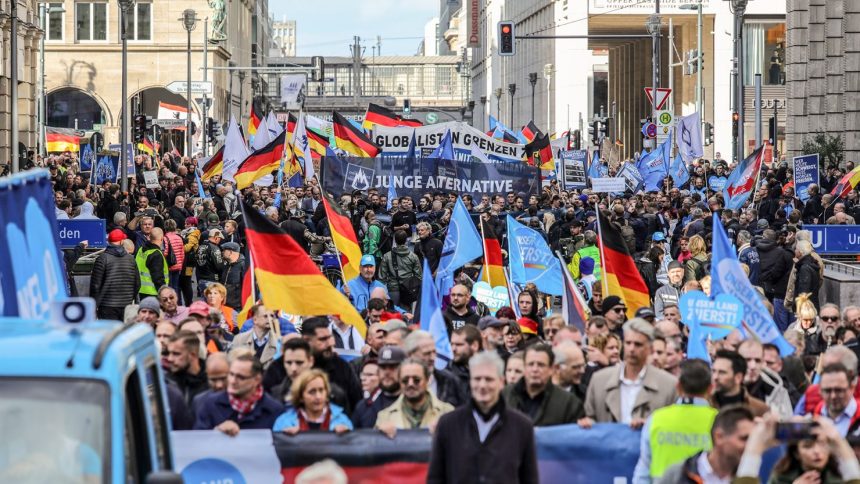 People march at a demonstration organized by the Alternative for Germany political party on October 8, 2022 in Berlin, Germany.