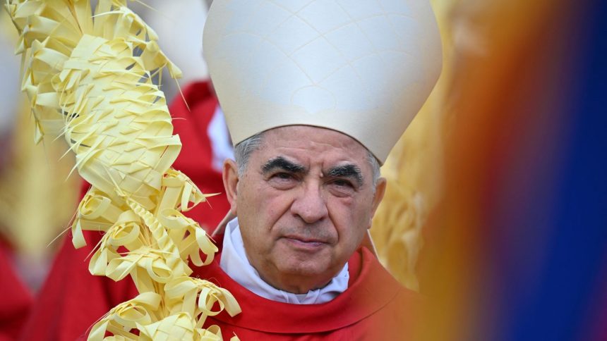 Italian Cardinal Giovanni Angelo Becciu takes par in the procession of the Palm Sunday mass on April 2, 2023 at St. Peter's Square in the Vatican.