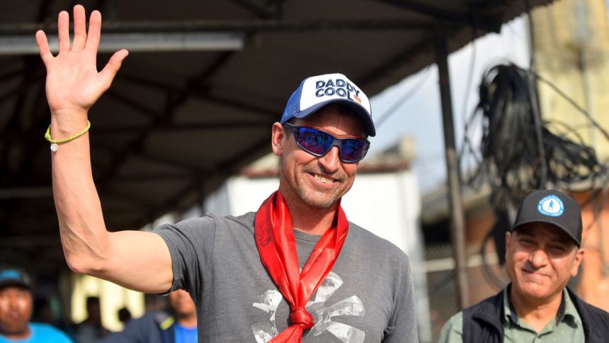 British mountaineer Kenton Cool waves to supporters at Kathmandu Airport in Nepal.