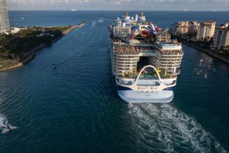 Royal Caribbean's Icon of the Seas heads out to sea from PortMiami in Florida. The world's largest cruise ship will soon be joined by more behemoth ships.