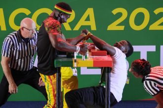 Ghana's Prince Affum (left) competes against Nigeria's Samual Nneka (R) in the Senior Men's 85KG left arm wrestling competition during the 13th African Games in Accra, Ghana in March 2024.