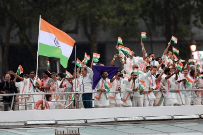 Sharath Kamal Achanta and V. Sindhu Pusarla, flagbearers of Team India, wave their national flag during the opening ceremony of the Olympic Games in Paris on July 26, 2024.