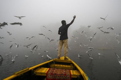 A man feeds seagulls on the smog engulfed waters of the Yamuna river in New Delhi, India, on November 14, 2024.