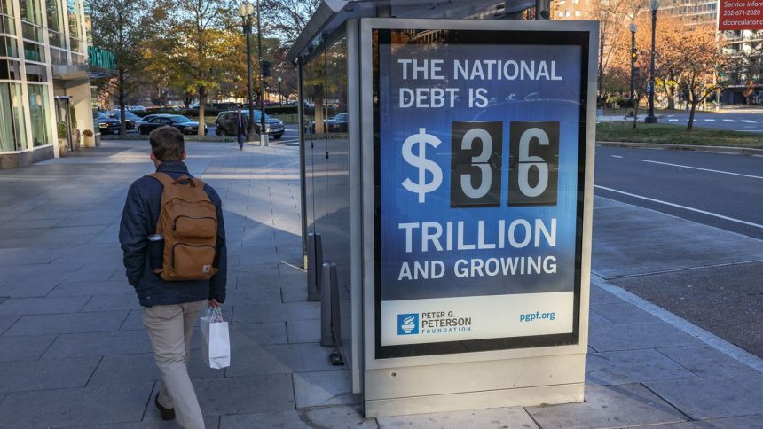 A bus shelter in Washington, DC, displays a billboard that says the US national debt is $36 trillion dollars in December 2024.