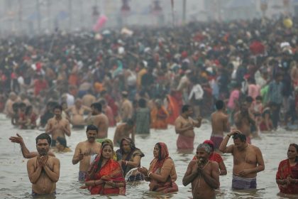 TOPSHOT - Hindu pilgrims take a dip in the sacred waters of Sangam, the confluence of Ganges, Yamuna and mythical Saraswati rivers during the Maha Kumbh Mela festival in Prayagraj on January 13, 2025. Vast crowds of Hindu pilgrims in India began bathing in sacred waters on January 13, as the Kumbh Mela festival opened, with organisers expecting 400 million people -- the largest gathering of humanity. (Photo by Niharika KULKARNI / AFP) (Photo by NIHARIKA KULKARNI/AFP via Getty Images)