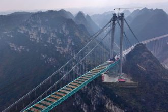 Aerial view of a construction site at the Huajiang Grand Canyon Bridge taken on January 17, 2025.