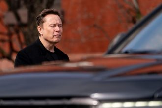 Elon Musk, chief executive officer of Tesla, walks to the Eisenhower Executive Office Building near the White House in Washington, DC.