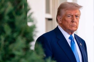 President Donald Trump awaits French President Emmanuel Macron outside the West Wing of the White House in February. The pair met to discuss the Russia-Ukraine war.