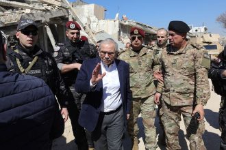 Lebanon's Prime Minister Nawaf Salam walks among Lebenese army soldiers as he visits the sourthern village of Khiam near the border with Israel, on February 28, 2025.