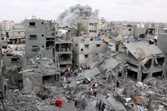 Palestinian rescuers check the site of Israeli bombardment on a residential building in Gaza City's Shujaiyya neighborhood on April 9.