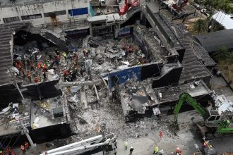 Rescue teams work at the Jet Set nightclub on Wednesday, a day after its roof collapsed killing at least 221 people in an incident that sent shockwaves around the country.