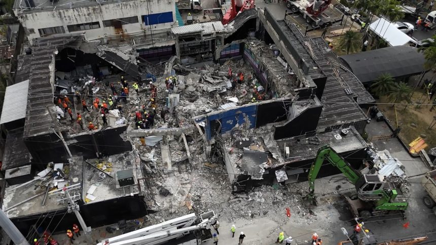 Rescue teams work at the Jet Set nightclub on Wednesday, a day after its roof collapsed killing at least 221 people in an incident that sent shockwaves around the country.