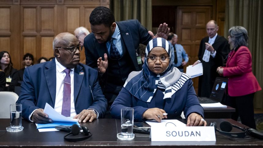 Muawia Osman Mohamed Khair (L), Sudan's acting justice minister, and Sudanese ambassador to the Netherlands Omaima Alsharief, wait for the start of a hearing before the International Court of Justice in The Hague, on Thursday.
