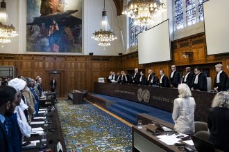 Delegation members from the United Arab Emirates and Sudan stand at the start of a hearing before the International Court of Justice in The Hague, on April 10, 2025.