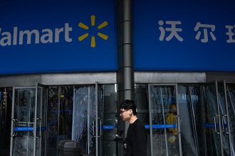 A man walks past a Walmart supermarket in Beijing on April 10, 2025.