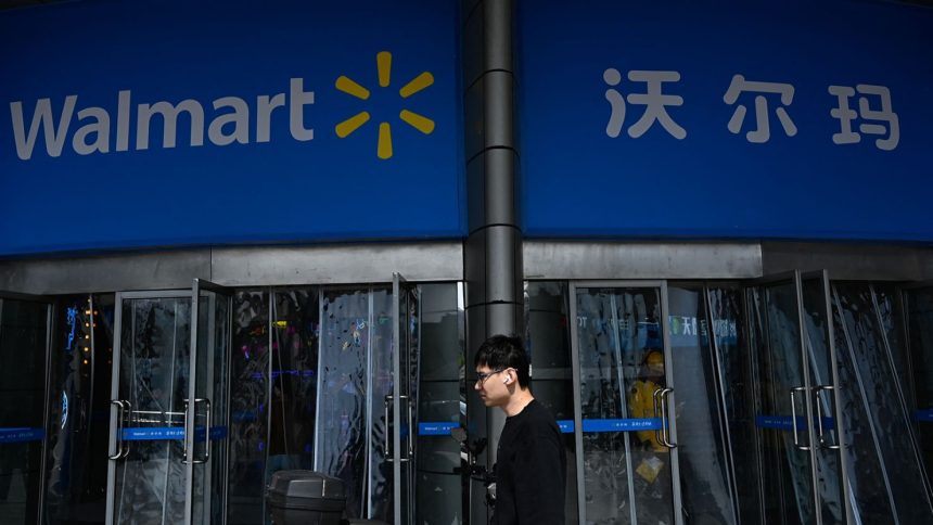 A man walks past a Walmart supermarket in Beijing on April 10, 2025.
