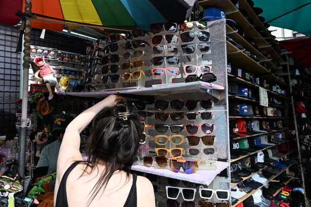 A shopper looks at sunglasses made in China at Santee Alley, in Los Angeles' Fashion District, known for inexpensive imported garments and accessories.