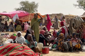 People who fled the Zamzam camp for the internally displaced after it fell under RSF control, rest in a makeshift encampment in an open field near the town of Tawila in war-torn Sudan's western Darfur region on April 13, 2025.