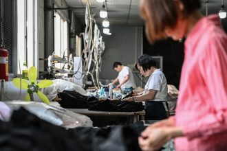 Employees produce garments for the online Chinese e-commerce company Temu at a clothing factory in Guangzhou in southern China's Guangdong province on April 16.